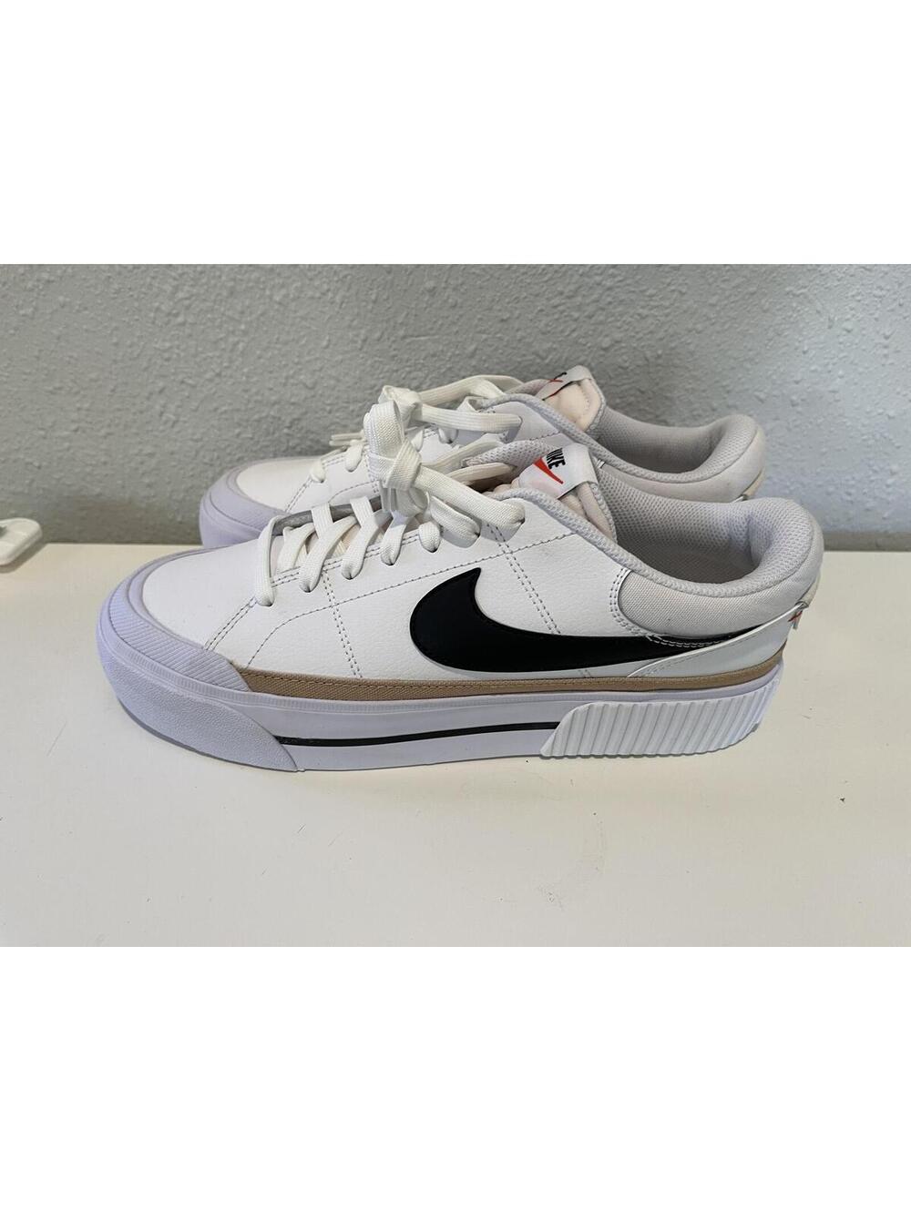 Nike White Low-Top Sneakers with Black Swoosh